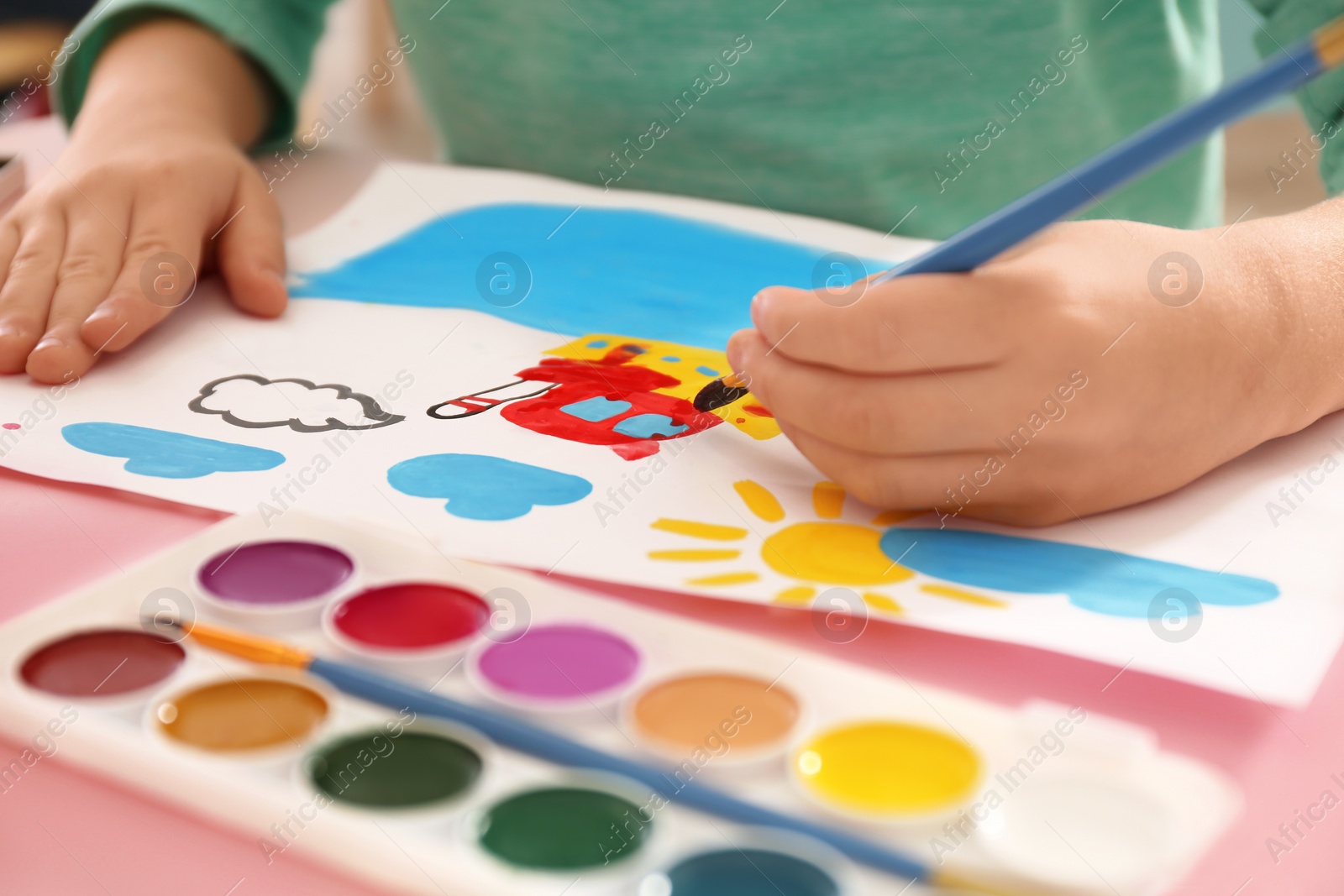 Photo of Little child painting at table, closeup view