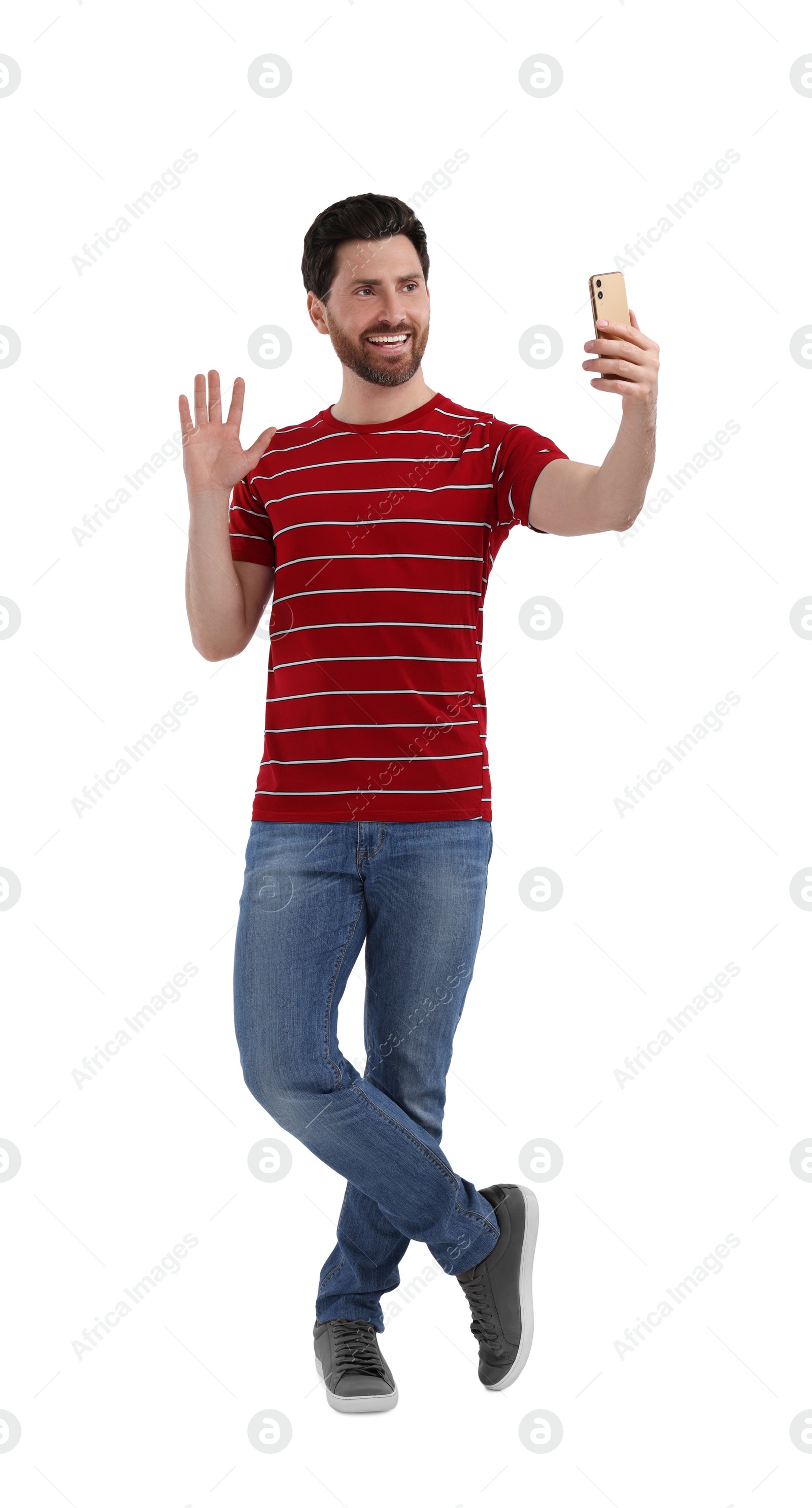 Photo of Smiling man taking selfie with smartphone on white background