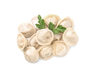 Pile of boiled dumplings with parsley leaves on white background, top view