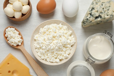 Photo of Different dairy products on white table, flat lay