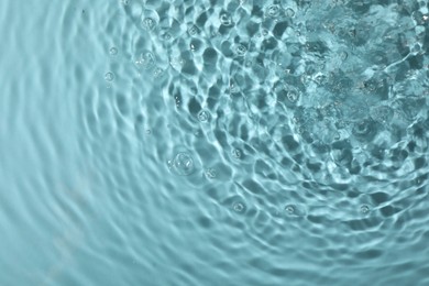 Photo of Closeup view of water with rippled surface on light blue background