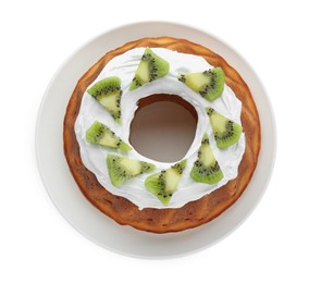 Homemade yogurt cake with kiwi and cream on white background, top view