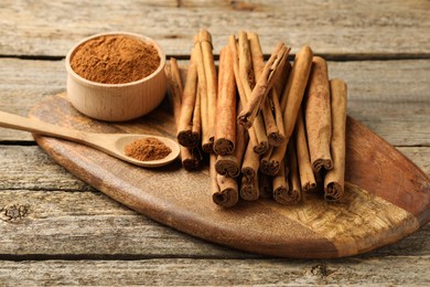 Cinnamon powder and sticks on wooden table