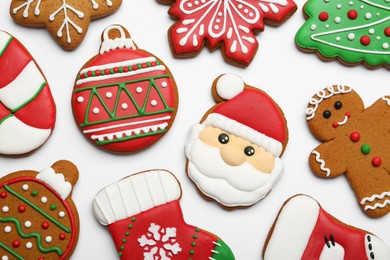 Photo of Different tasty Christmas cookies on white background, flat lay