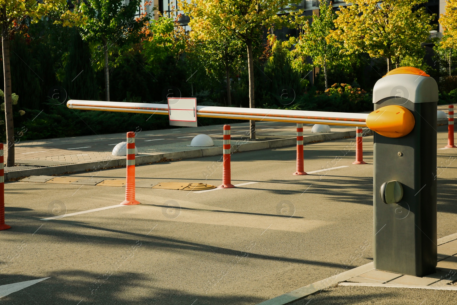 Photo of Closed boom barrier outdoors on sunny day