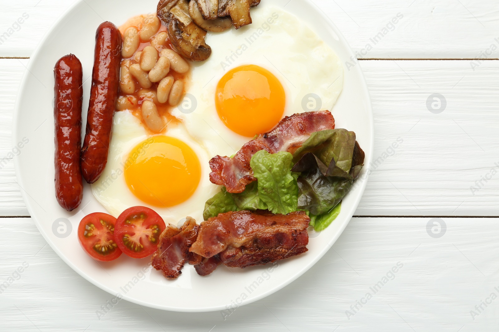 Photo of Delicious breakfast with sunny side up eggs on white wooden table, top view