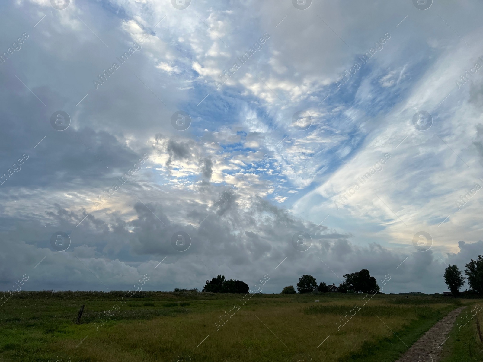 Photo of Picturesque view of green field and cloudy sky