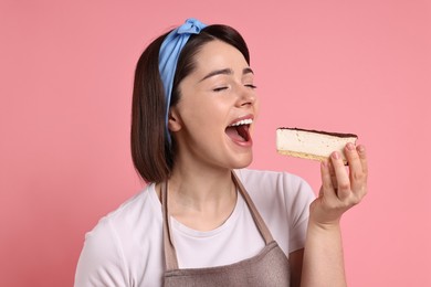 Photo of Happy confectioner eating cheesecake on pink background
