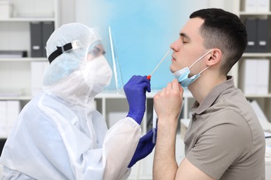 Photo of Laboratory testing. Doctor in uniform taking sample from patient's nose with cotton swab at hospital