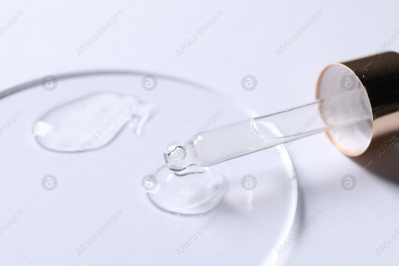 Photo of Samples of cosmetic serum and pipette on white background, closeup