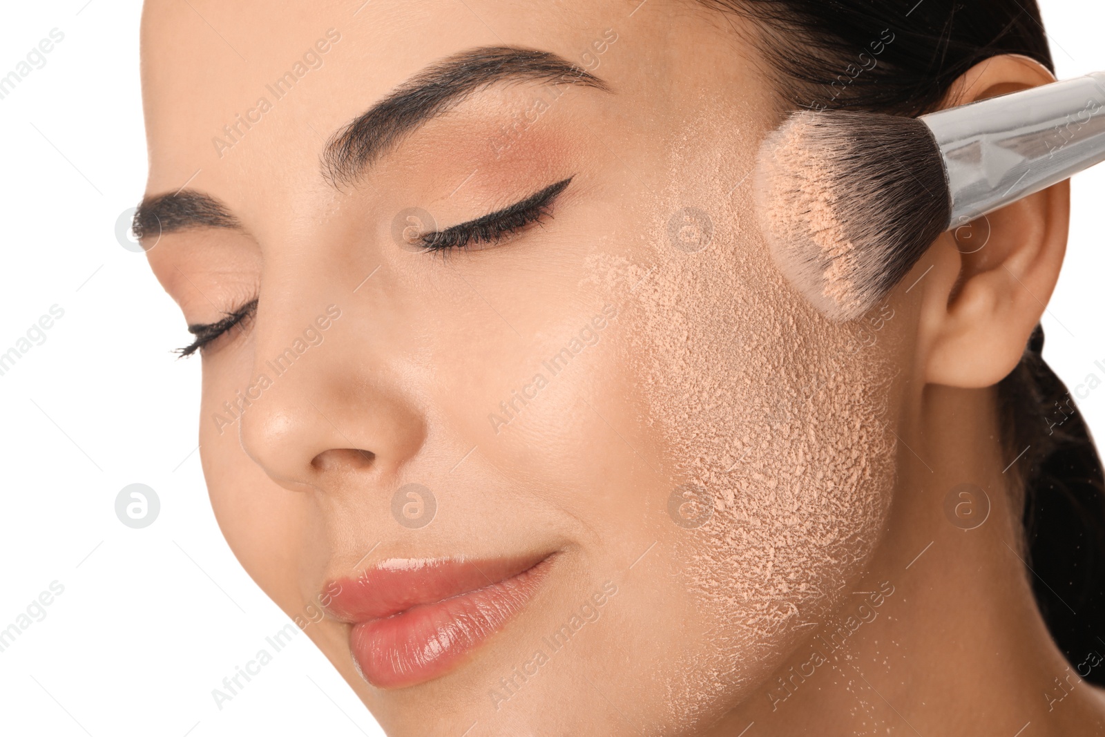 Photo of Beautiful young woman applying face powder with brush on white background, closeup
