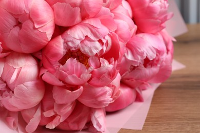 Bouquet of beautiful pink peonies on wooden table, closeup