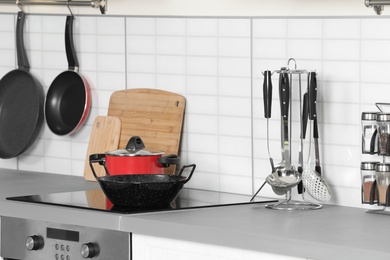 Photo of Clean cookware and utensils in modern  kitchen