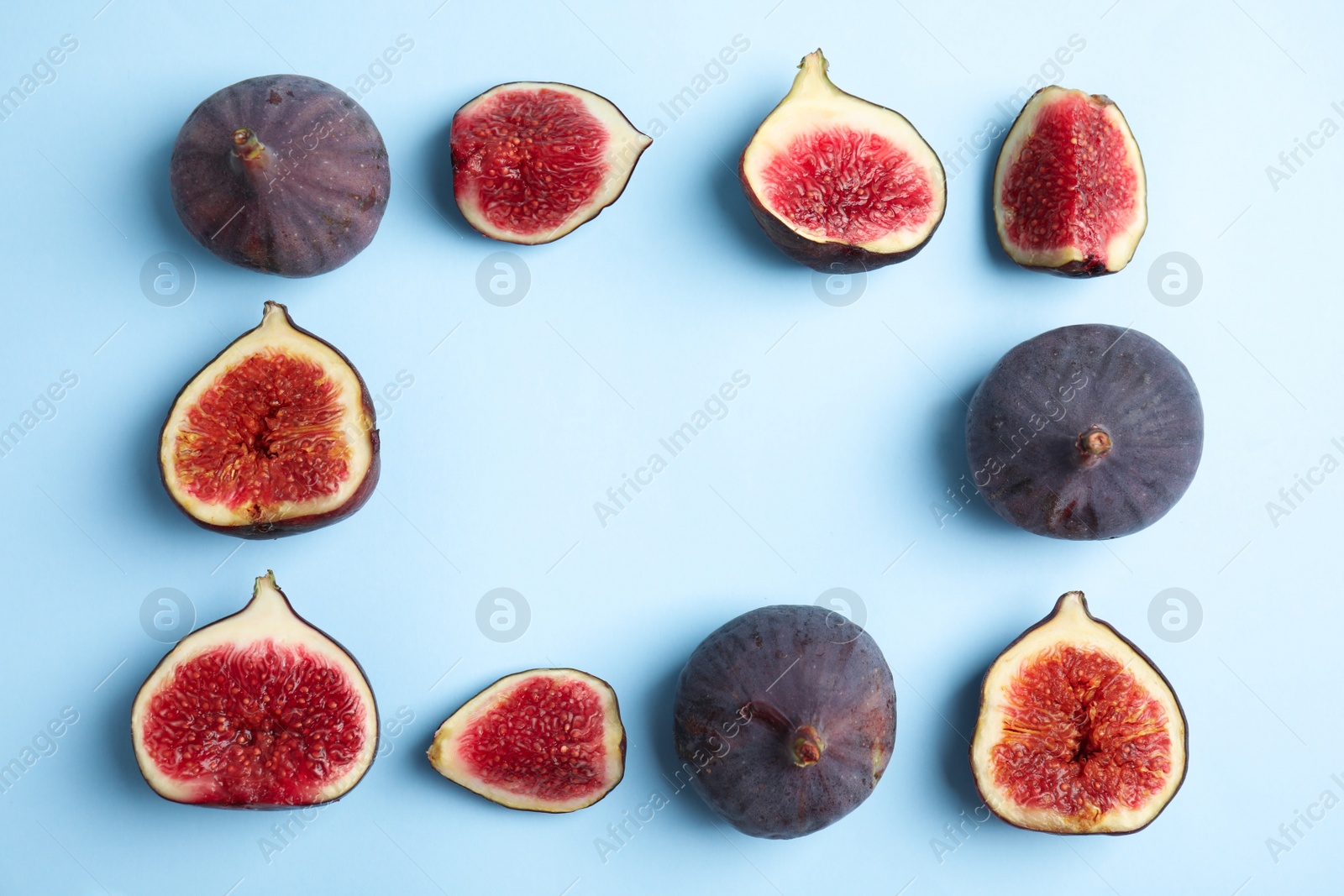 Photo of Delicious ripe figs on light blue background, flat lay. Space for text