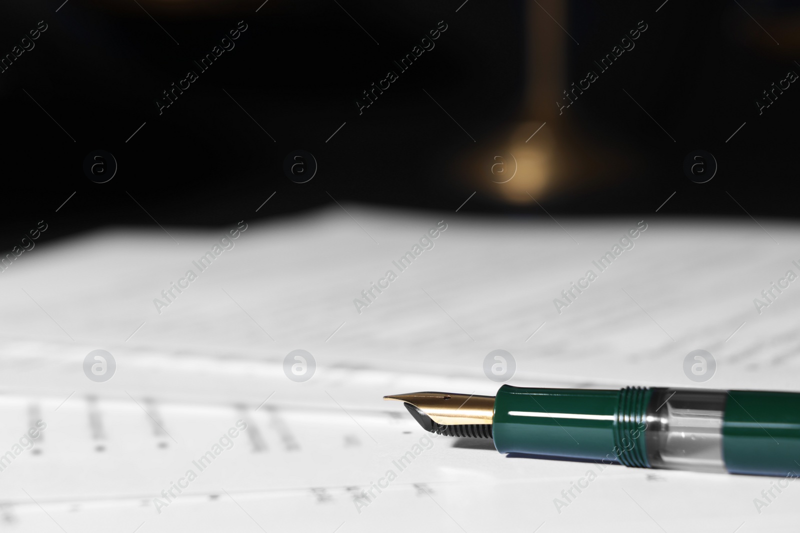 Photo of Fountain pen and paper documents on table, closeup with space for text. Notary service