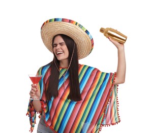 Young woman in Mexican sombrero hat and poncho with shaker and cocktail on white background