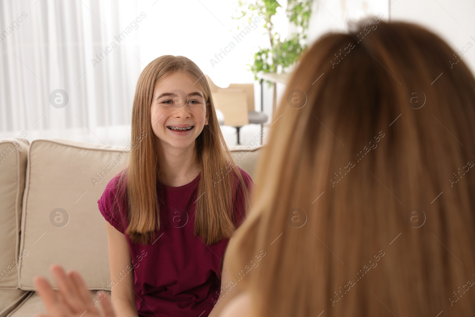Photo of Mother talking with her teenager daughter at home