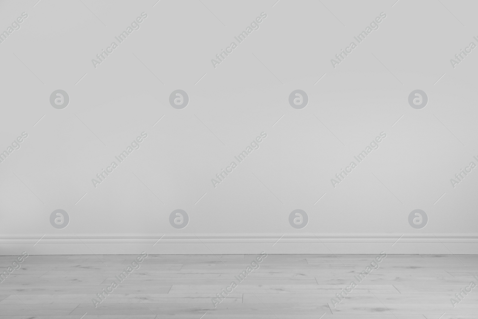 Photo of Empty white wall and wooden floor in room