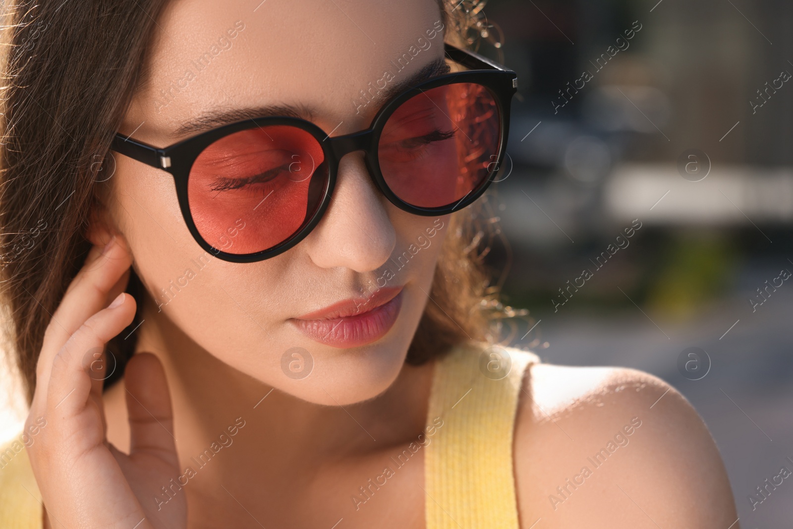 Photo of Beautiful woman in sunglasses outdoors, closeup. Space for text