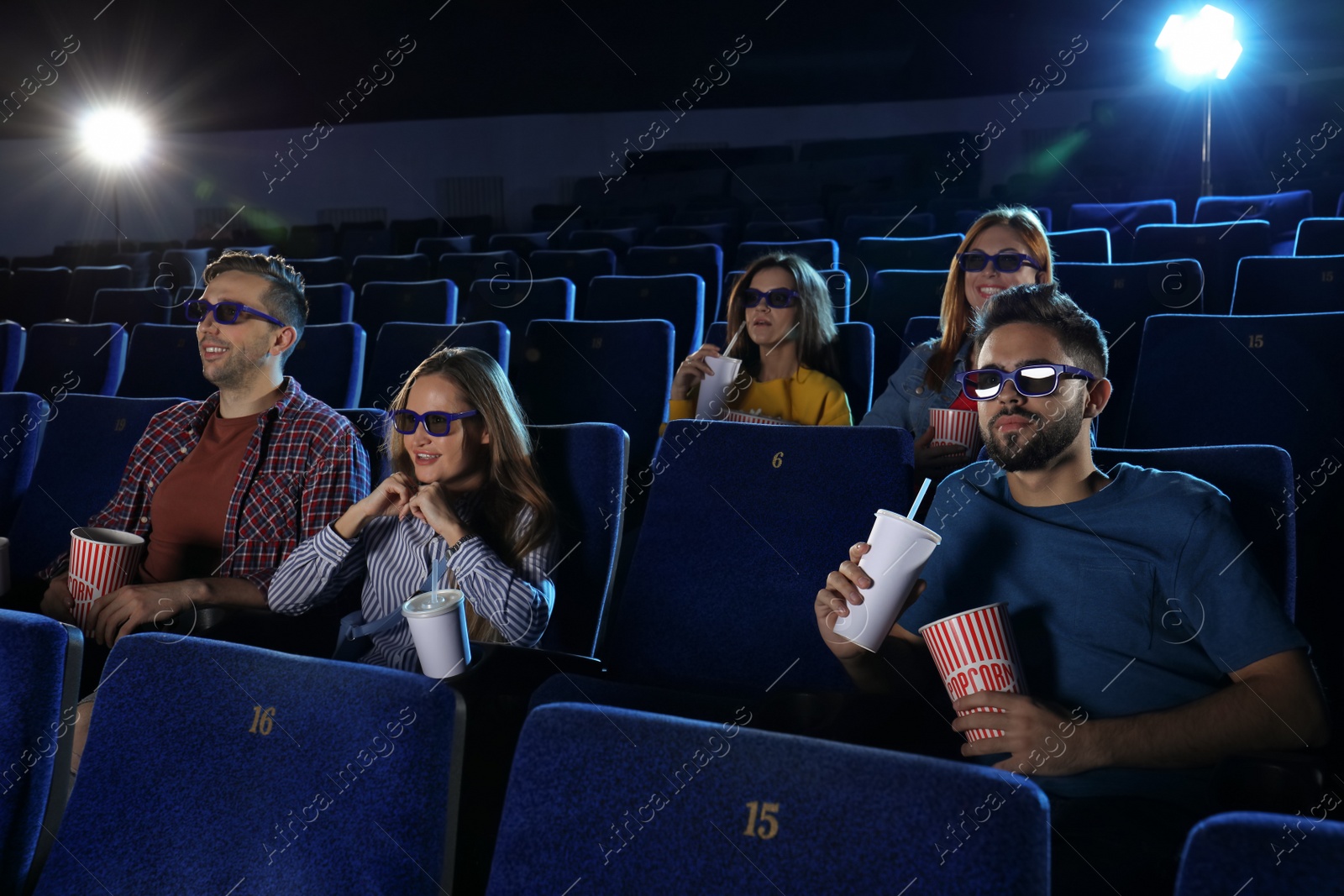 Photo of Young people watching movie in cinema theatre