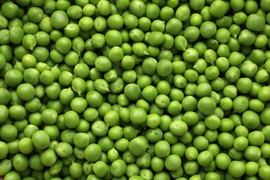 Photo of Fresh raw green peas as background, top view