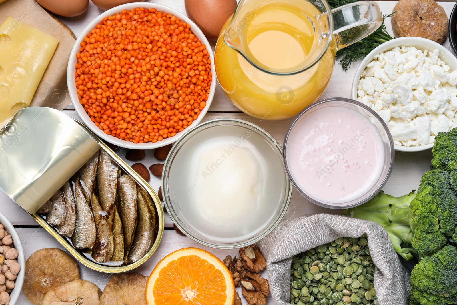 Photo of Set of natural food high in calcium on white wooden table, flat lay