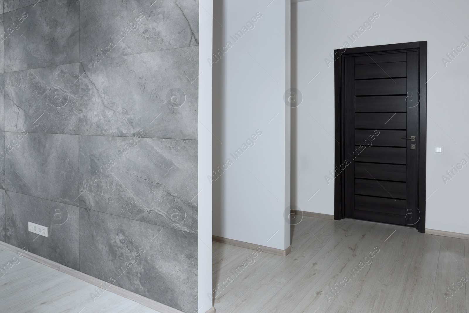 Photo of Empty renovated room with walls and black door