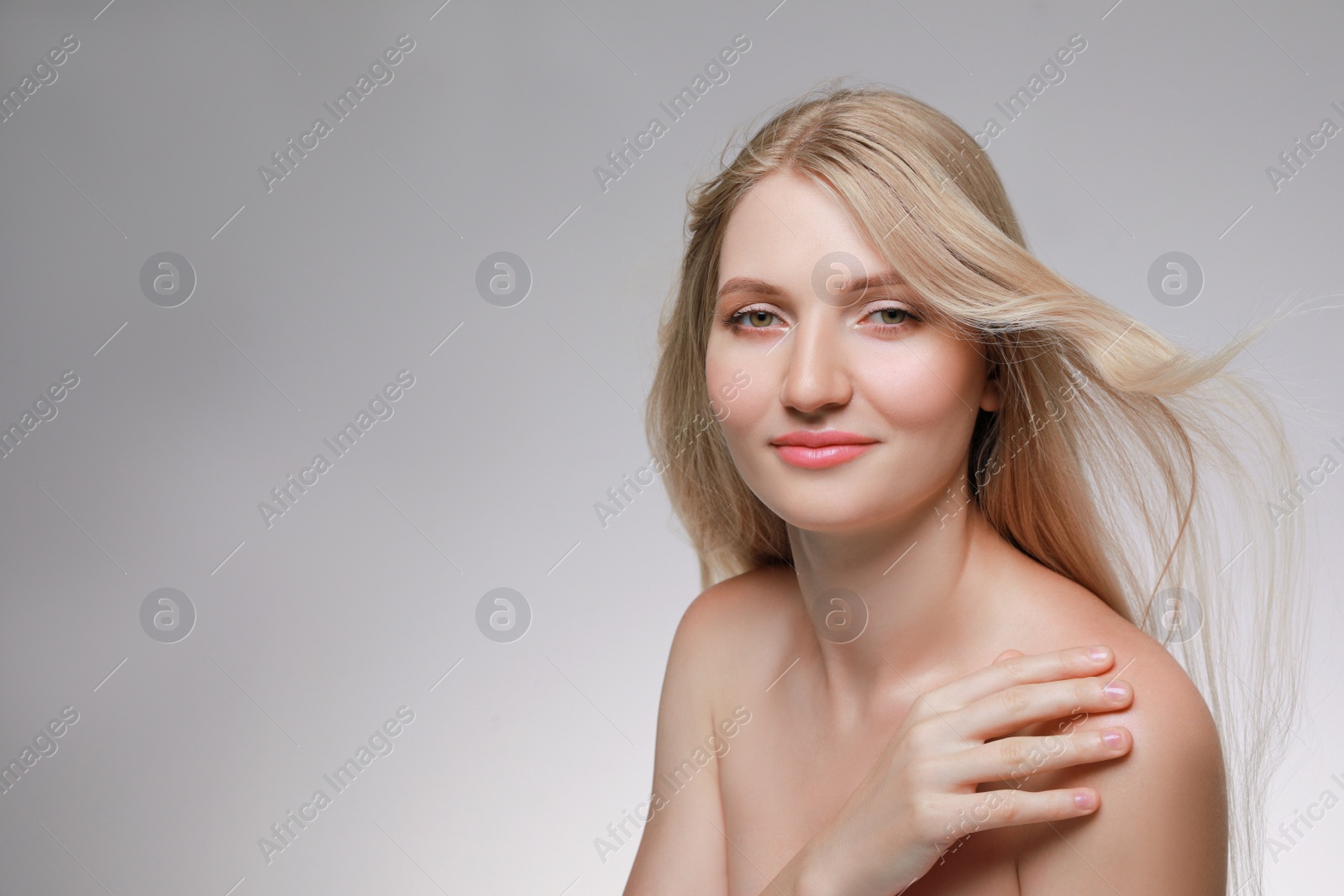 Photo of Portrait of young woman with beautiful face on beige background. Space for text