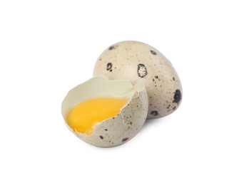 Whole and cracked quail eggs on white background