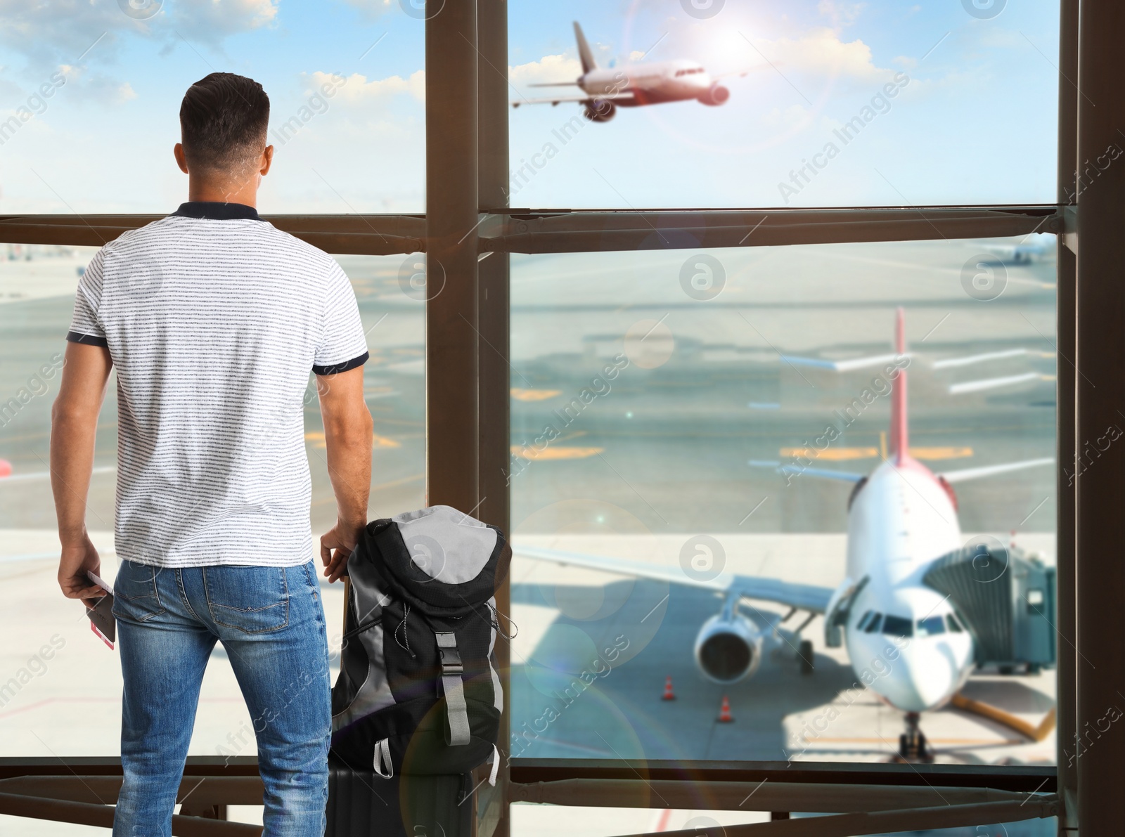 Image of Man with backpack and travel suitcase at airport terminal. Summer vacation