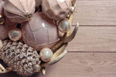 Photo of Collection of beautiful Christmas tree baubles on wooden table, closeup. Space for text