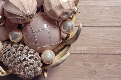 Collection of beautiful Christmas tree baubles on wooden table, closeup. Space for text