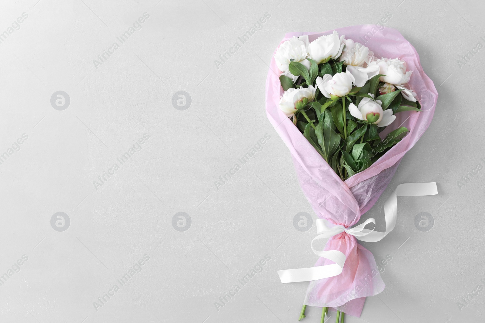 Photo of Bouquet of beautiful flowers on grey background, top view