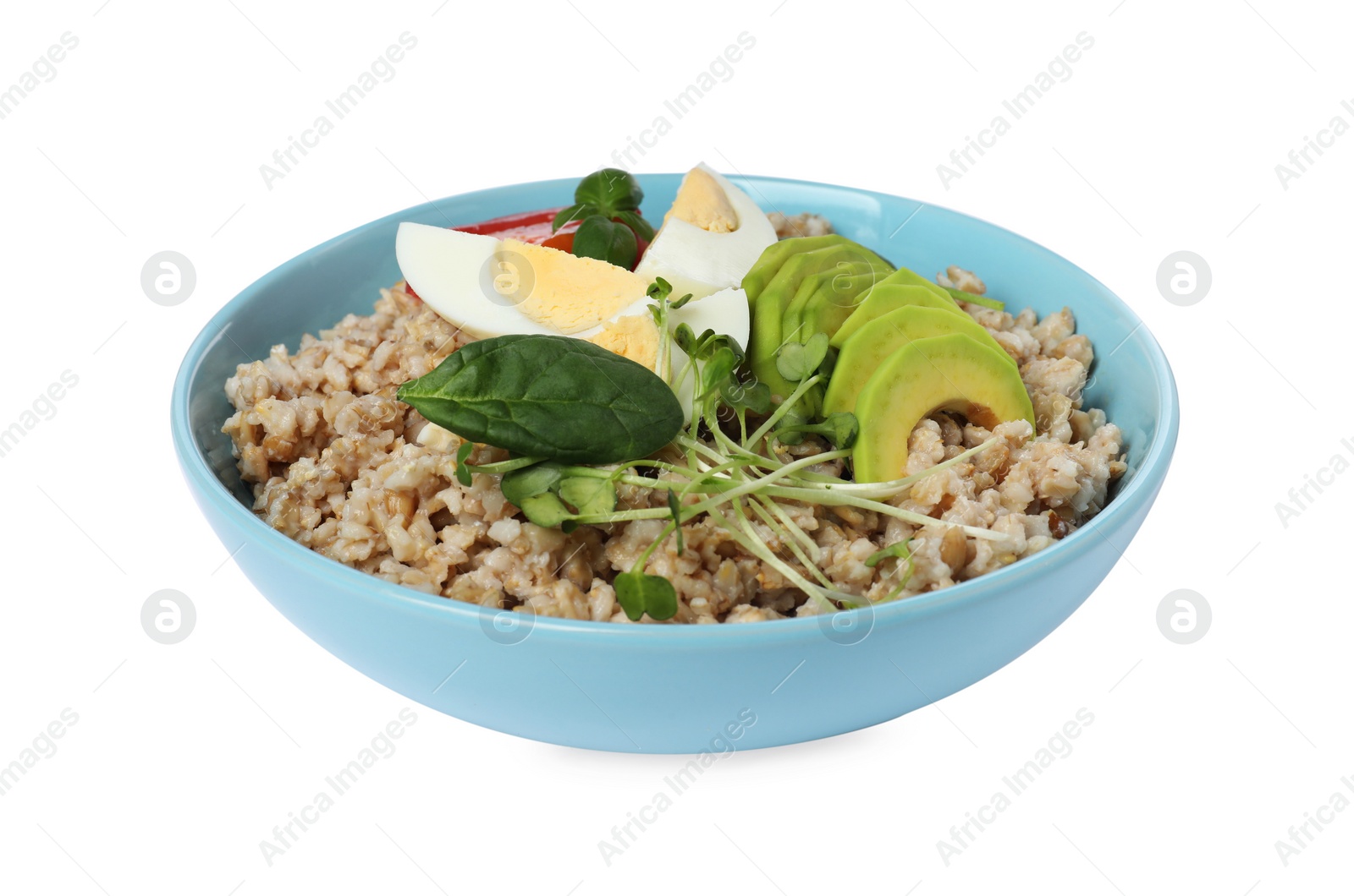 Photo of Delicious boiled oatmeal with egg, avocado and basil in bowl isolated on white