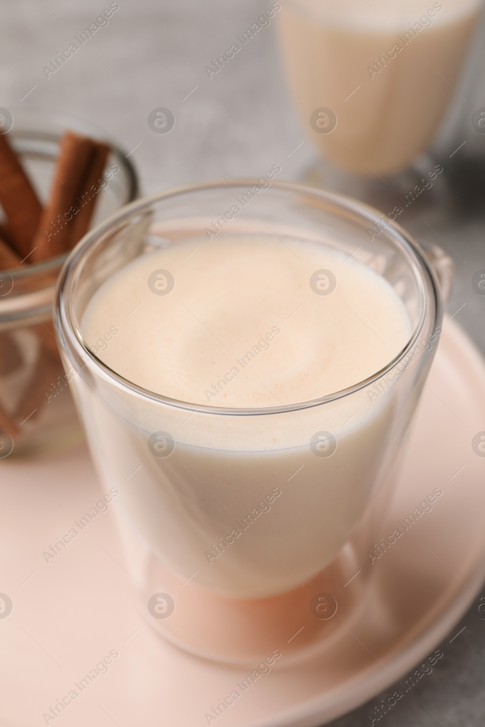 Photo of Delicious eggnog with cinnamon on light grey table