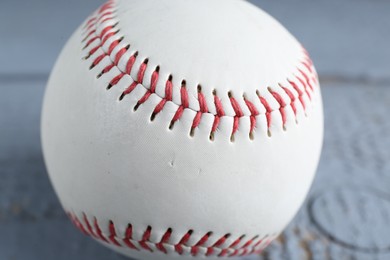 Photo of Baseball ball on grey wooden table, closeup view