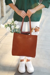 Photo of Woman with leather shopper bag outdoors, closeup