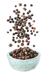 Image of Different peppercorns falling into bowl on white background