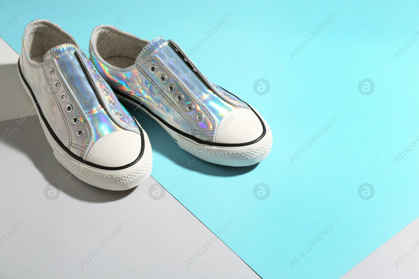 Photo of Pair of stylish sneakers on color background. Space for text