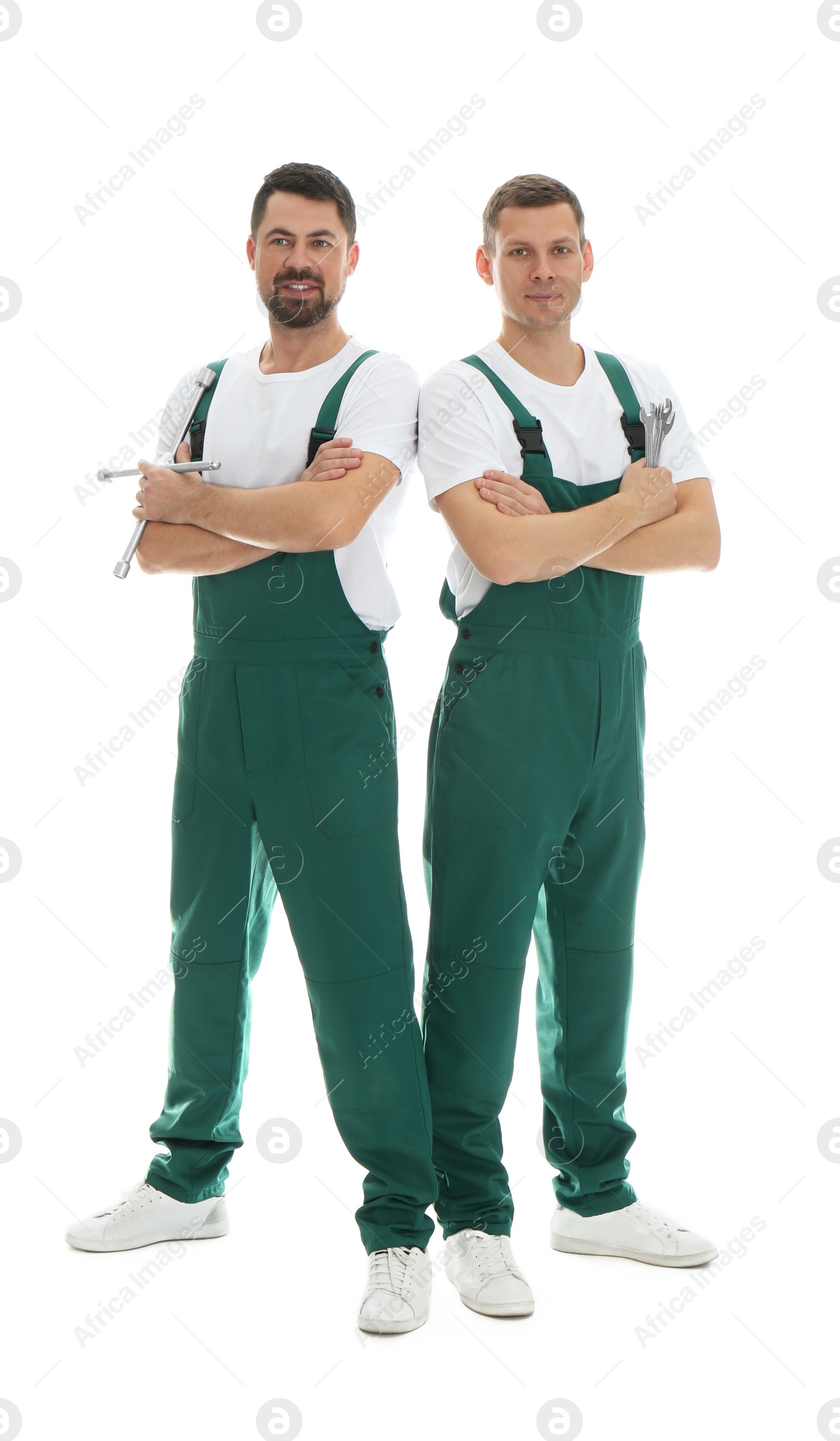 Photo of Full length portrait of professional auto mechanics on white background