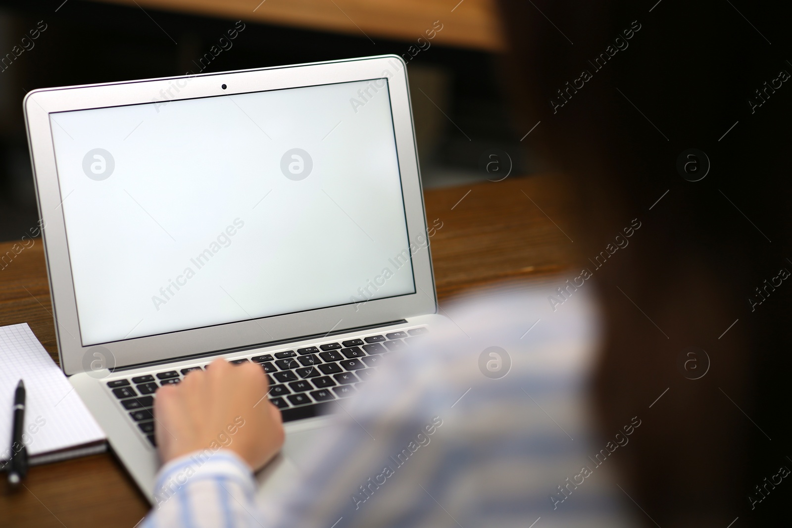 Photo of Woman working on modern laptop at table, closeup