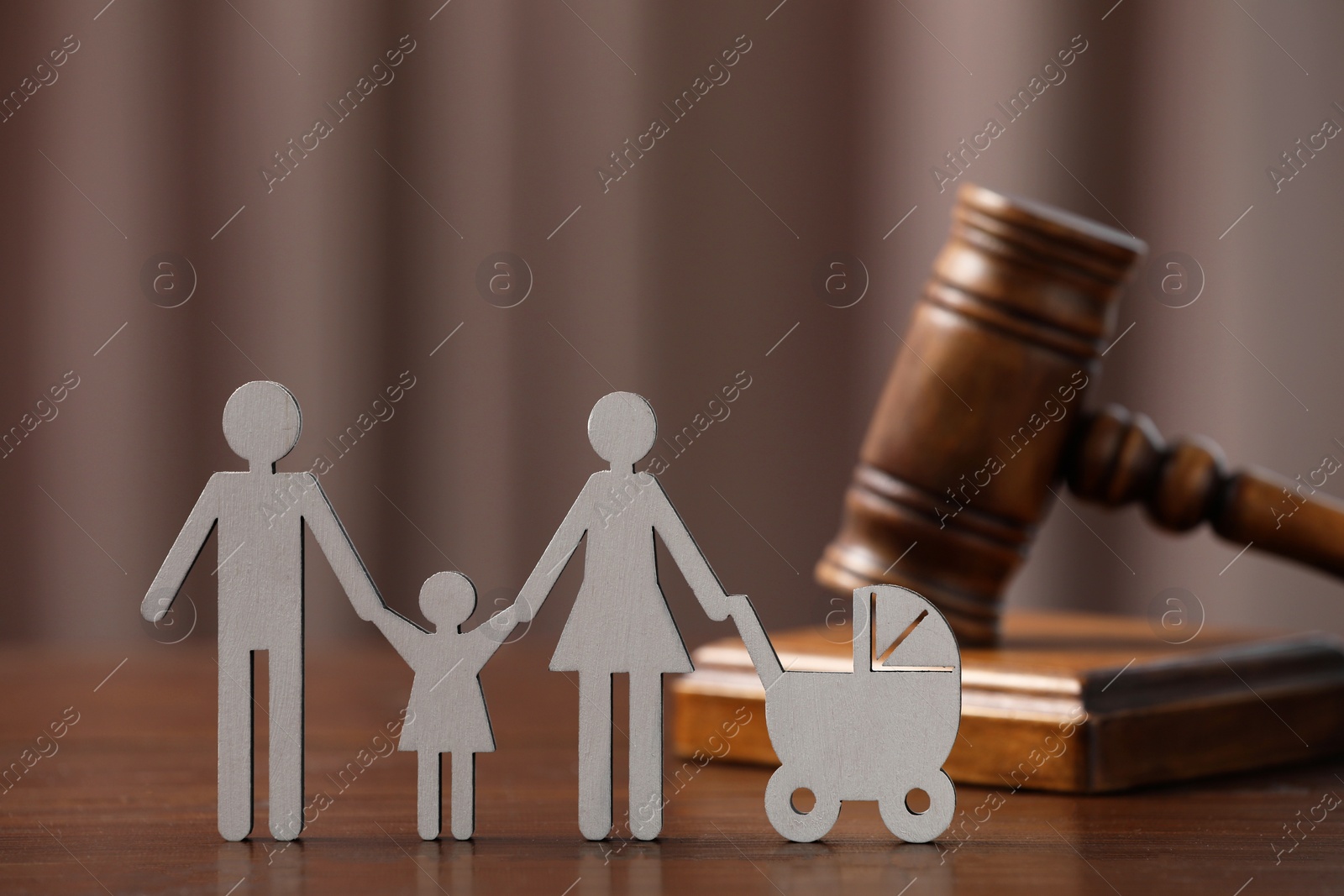 Photo of Family law. Figure of parents with children and gavel on wooden table