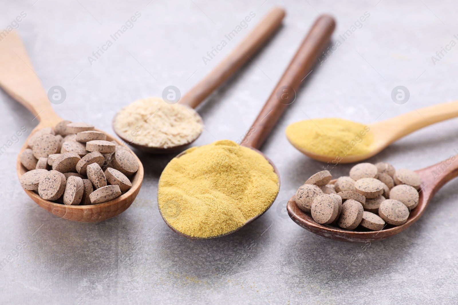 Photo of Different types of brewer's yeast on grey table, closeup