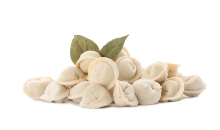 Photo of Raw meat dumplings with bay leaves on white background