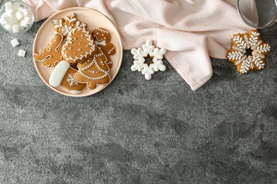 Flat lay composition with delicious homemade Christmas cookies on grey table. Space for text