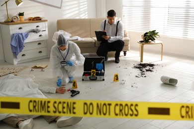 Investigators working at crime scene with dead body