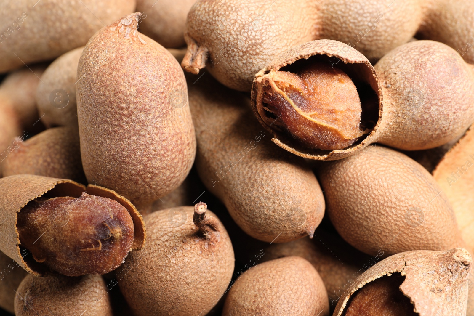 Photo of Pile of delicious ripe tamarinds as background, closeup