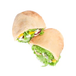 Delicious pita sandwiches with chicken breast and vegetables on white background, top view