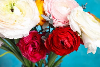 Photo of Bouquet with beautiful ranunculus flowers on color background, closeup