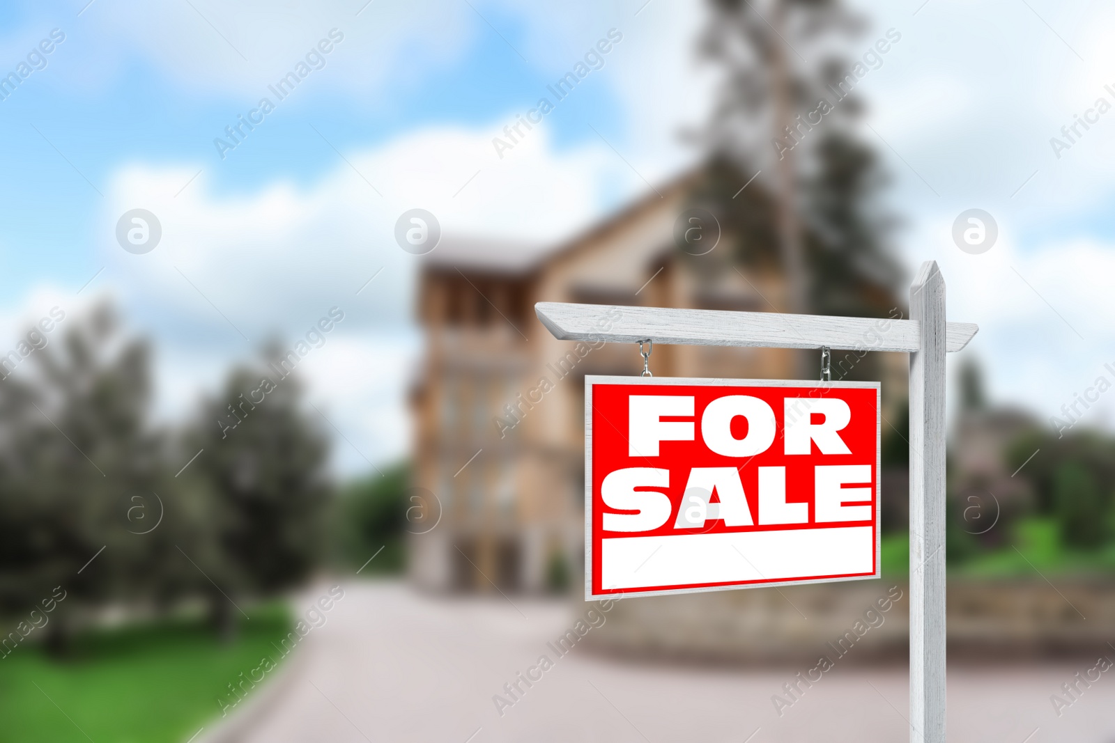 Image of Red real estate sign with inscription FOR SALE near house outdoors on sunny day, space for text 